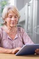Mature woman using her digital tablet
