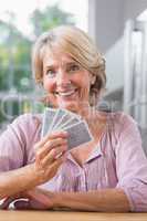 Smiling woman playing cards