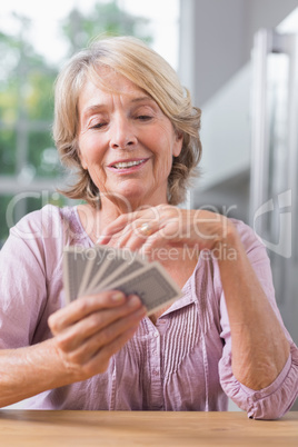 Happy woman playing cards