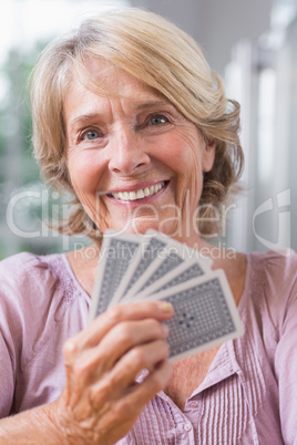 Close up of a smiling woman playing cards Close up of a smiling woman playing cards