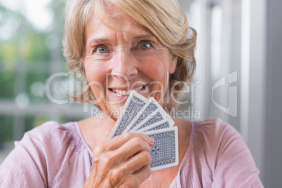 Close up of a happy woman playing cards