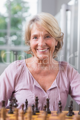 Smiling woman playing chess