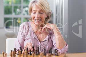 Mature woman playing chess