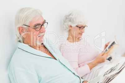 Husband and wife reading in bed