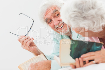 Husband smiling at wife in bed