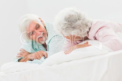 Chatting couple in bed