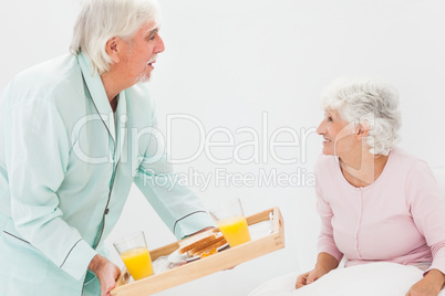 Husband bringing wife breakfast in bed