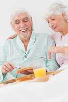 Couple enjoying breakfast in bed