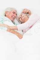 Couple embracing in bed