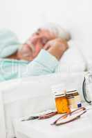 Bedside table with pills and glasses