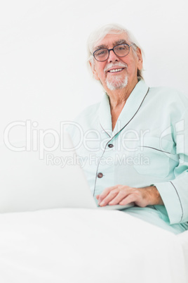Man using laptop in bed