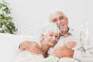 Couple hugging on couch