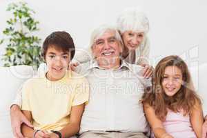 Grandparents with grandchildren on the sofa