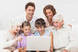 Extended family looking at laptop