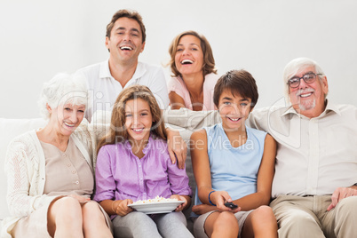 Multi-generation family on couch watching tv