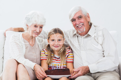 Little girl celebrating birthday with grandparents