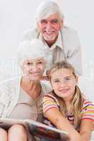 Little girl smiling with grandparents