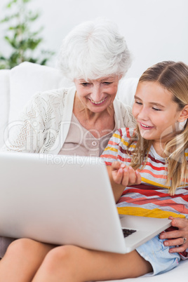 Granny and little girl using laptop