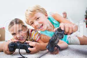 Siblings having fun playing video games