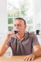 Man drinking glass of red wine