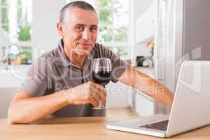 Happy man at kitchen table