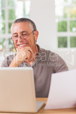 Happy man working at laptop