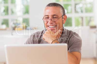 Smiling man at laptop