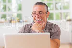 Smiling man at laptop