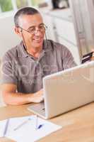 Man online shopping with laptop