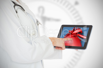 Doctor showing her tablet with red heart