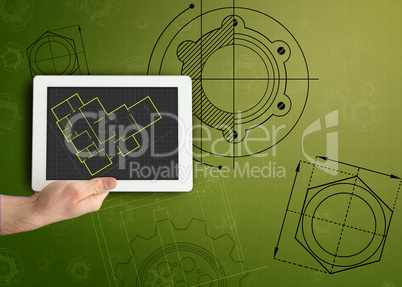 Tablet and plan on green background