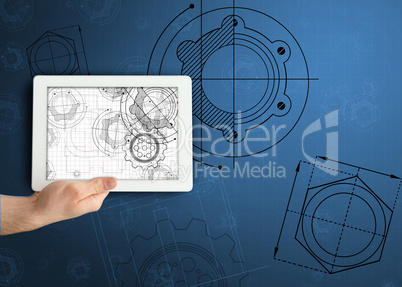 Hand holding tablet with architect illustrations