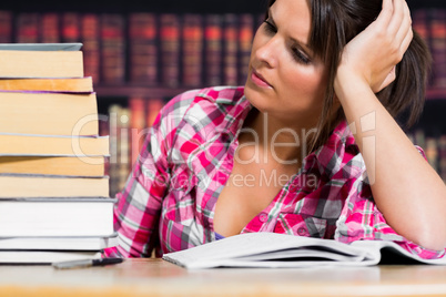 Woman thinking in the library