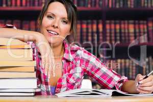 Woman leaning on books with a smile