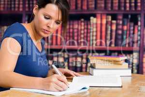 Cute woman writing on notebook