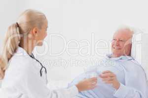 Doctor handing glass of water to patient