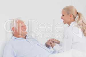 Doctor comforting elderly patient
