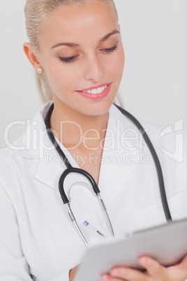 Smiling doctor consulting tablet pc