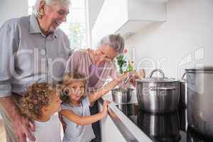 Children cooking with grandparents