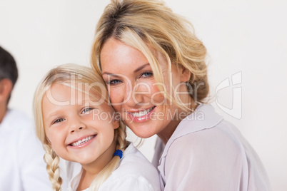 Mother embracing young daughter