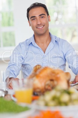 Man sitting at head of dinner table