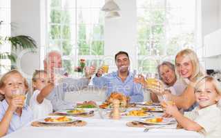 Happy family toasting at thanksgiving dinner