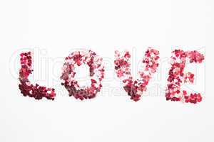 Pink confetti spelling out love