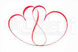 Pink ribbon shaped into intertwining hearts