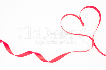 Pink ribbon shaped into heart with copy space