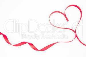Pink ribbon shaped into heart with copy space
