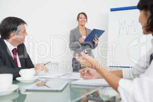 Businesswoman explaining with a clipboard