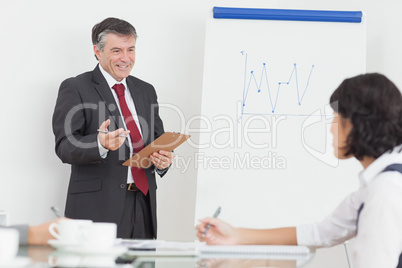 Businessman explaining to his colleague with big smile