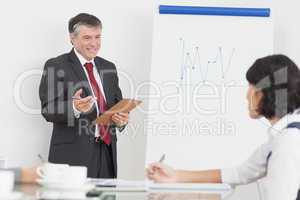 Businessman explaining to his colleague with big smile