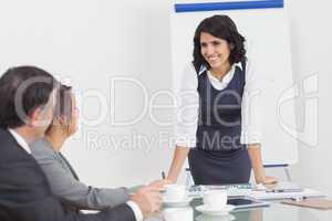 Businesswoman leaning on desk